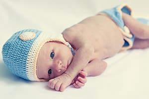 Cute beautiful baby is wearing a funny hat